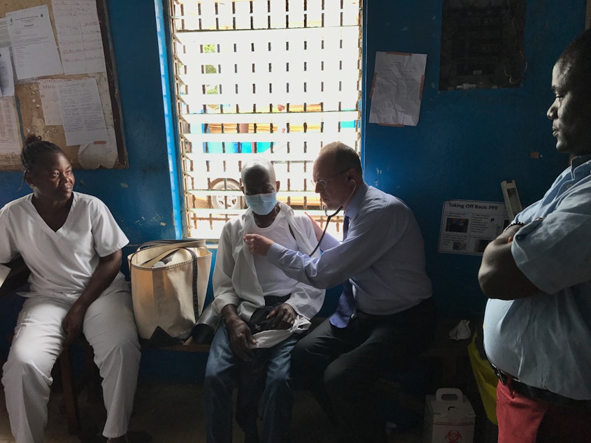 caption: Dr. Paul Farmer examines a tuberculosis patient in Monrovia, Liberia.