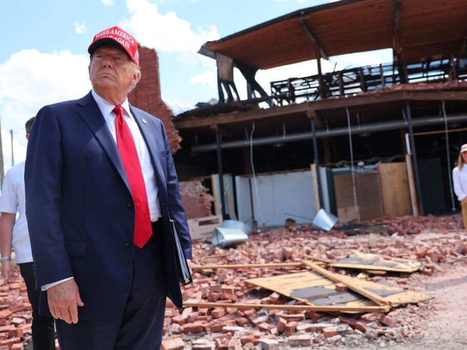 caption: Former President Donald Trump visits Chez What Furniture Store, which was damaged during Hurricane Helene, on Sept. 30 in Valdosta, Ga.