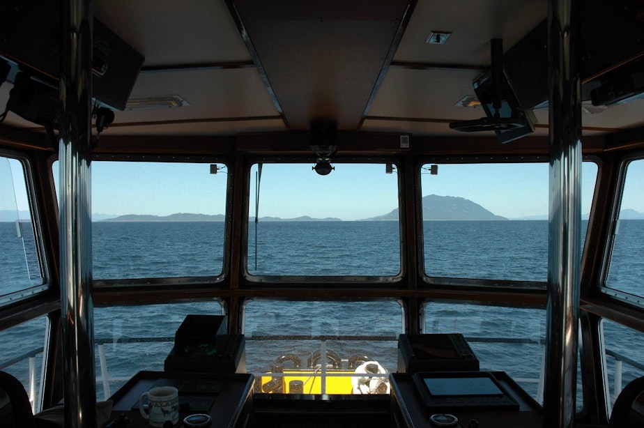 caption: The view from the wheelhouse of the Pacific Titan tugboat along the Inside Passage to Alaska.