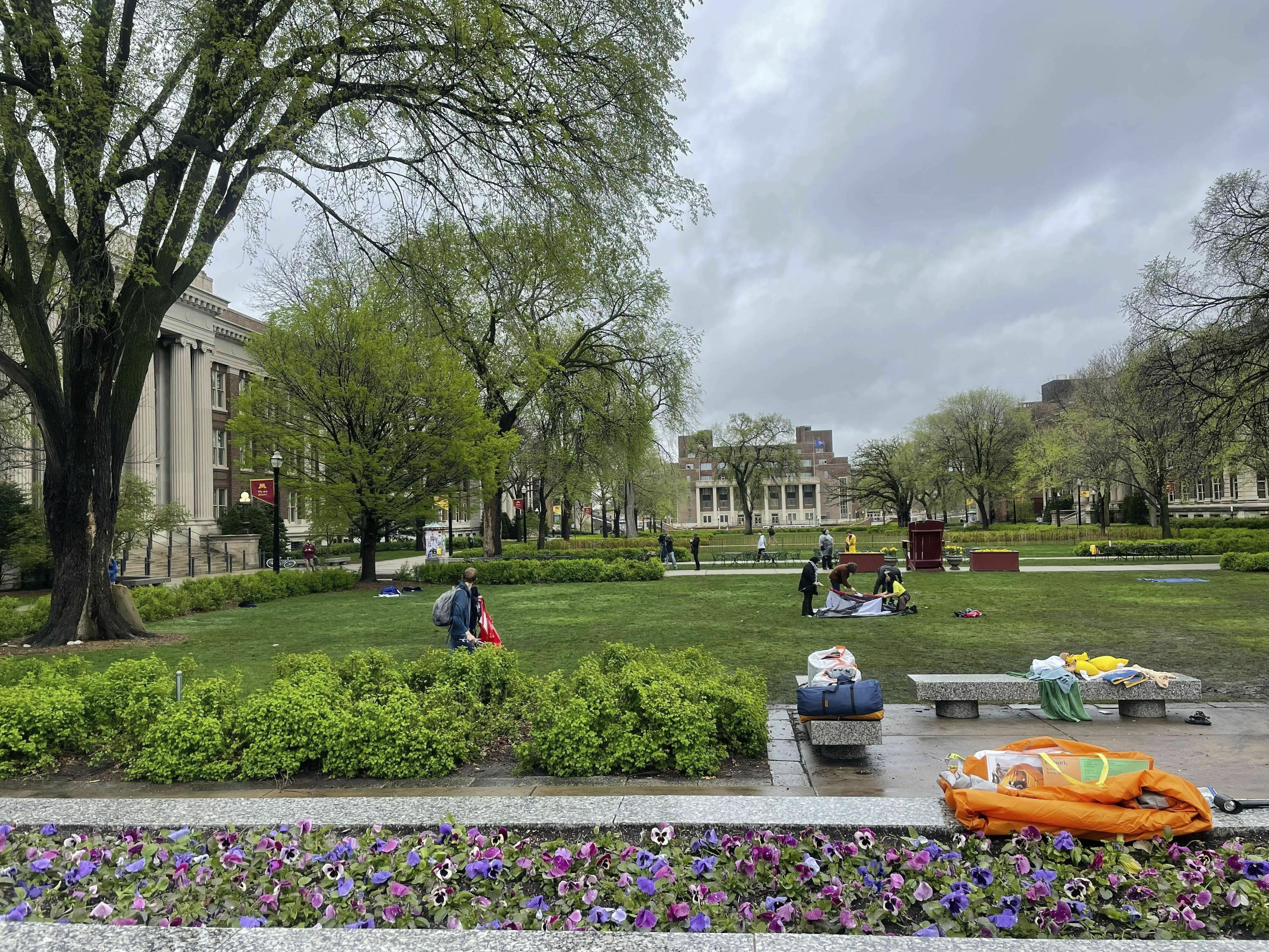 caption: People take down the pro-Palestinian encampment at the University of Minnesota in Minneapolis, Minn., on Thursday.