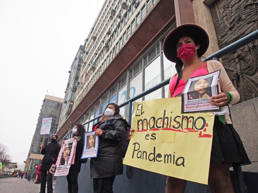caption: Demonstrators in front of the prosecutor's office in Lima, Peru, protest gender violence and femicide on June 20.