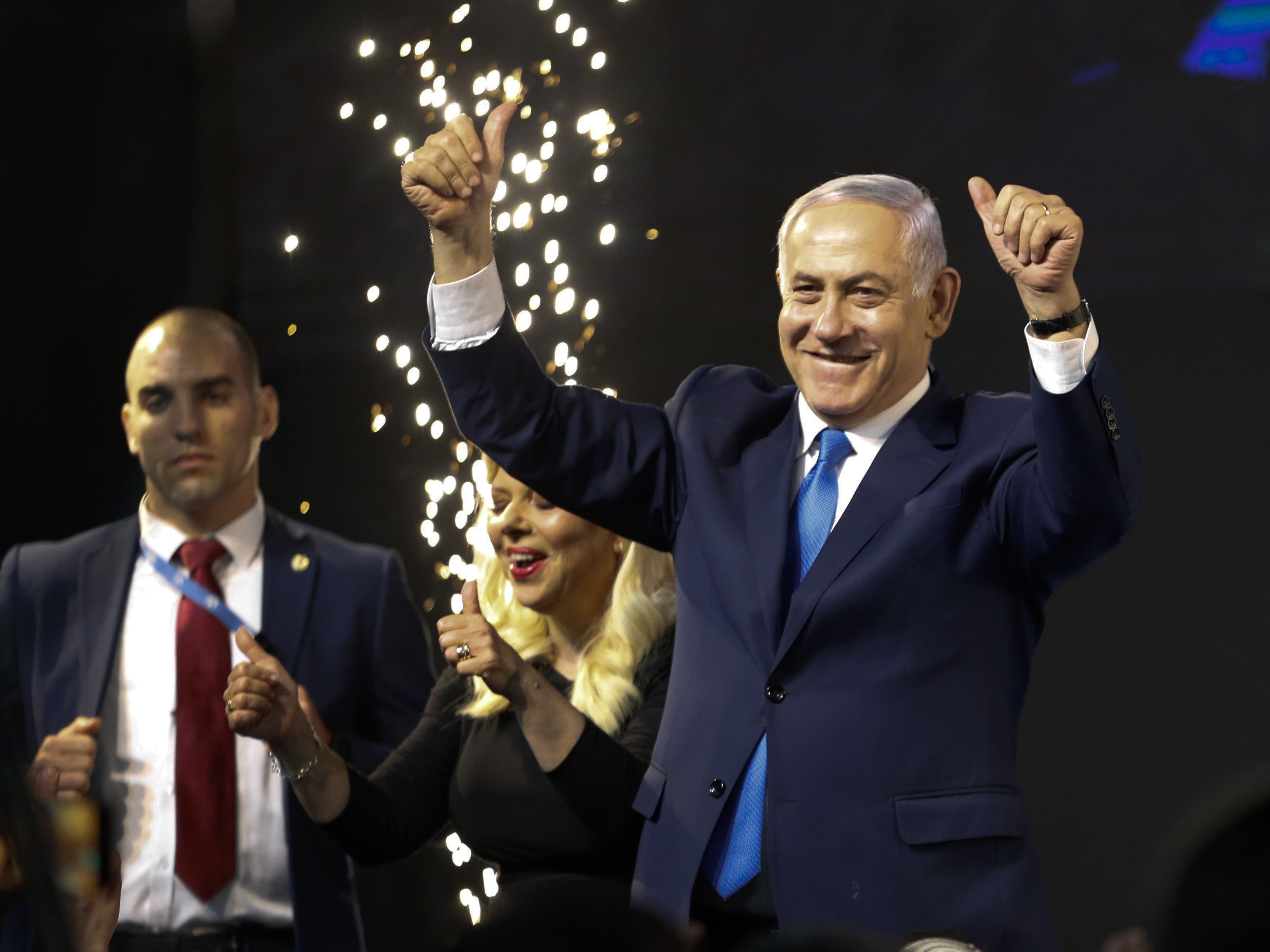 caption: Israel's Prime Minister Benjamin Netanyahu waves to his supporters in Tel Aviv after polls for Israel's general elections closed.
