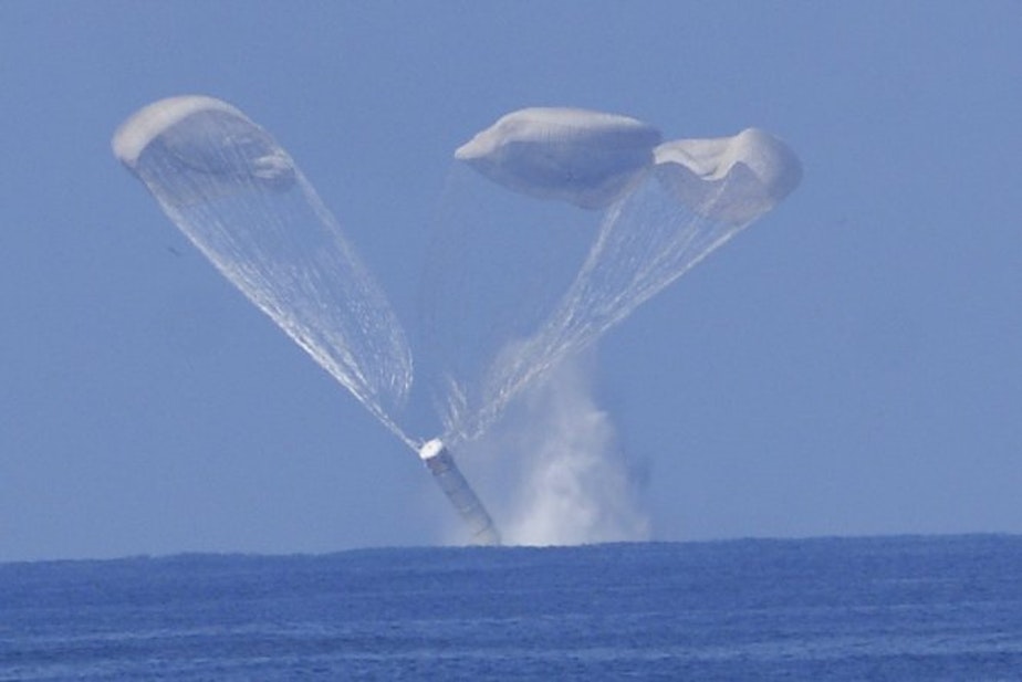 caption: The space shuttle twin solid rocket boosters separate from the orbiter and land in the ocean, where they are collected for reuse by NASA.