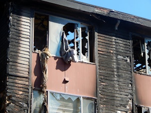 caption: Fire damage to the Lam Bow apartments in West Seattle's Delridge neighborhood.