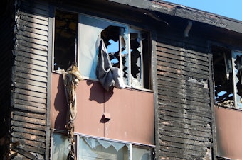 caption: Fire damage to the Lam Bow apartments in West Seattle's Delridge neighborhood.