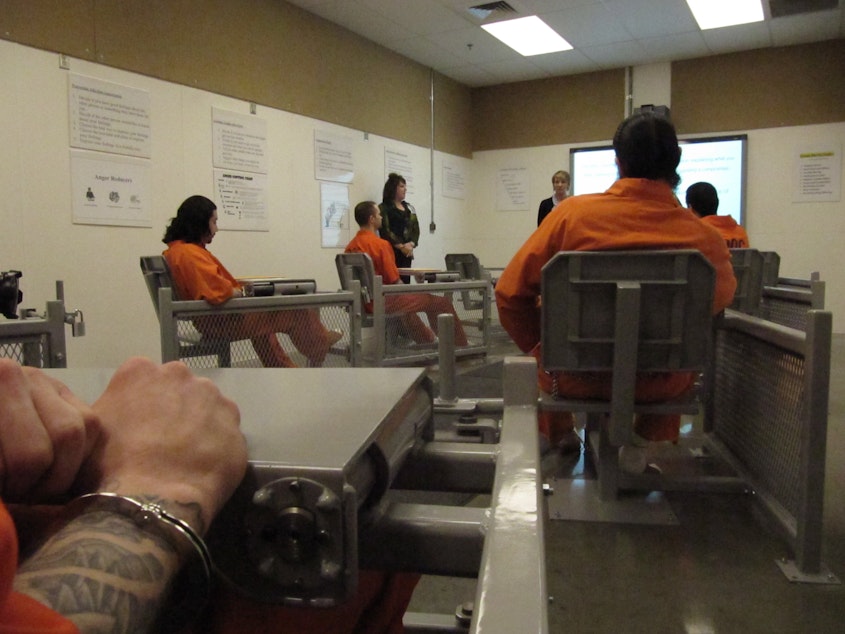 caption: Several inmates at the Washington State Penitentiary in Walla Walla, Wash. gather for classes March 14, 2013 for training in several areas, including anger management, as part of a new program intended to reduce violence inside the prison.