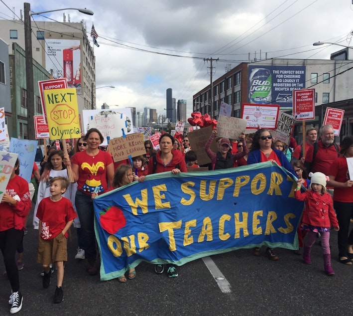 caption: Teachers and supporters march down First Avenue South on their way to the Seattle Public Schools headquarters south of downtown on Tuesday.