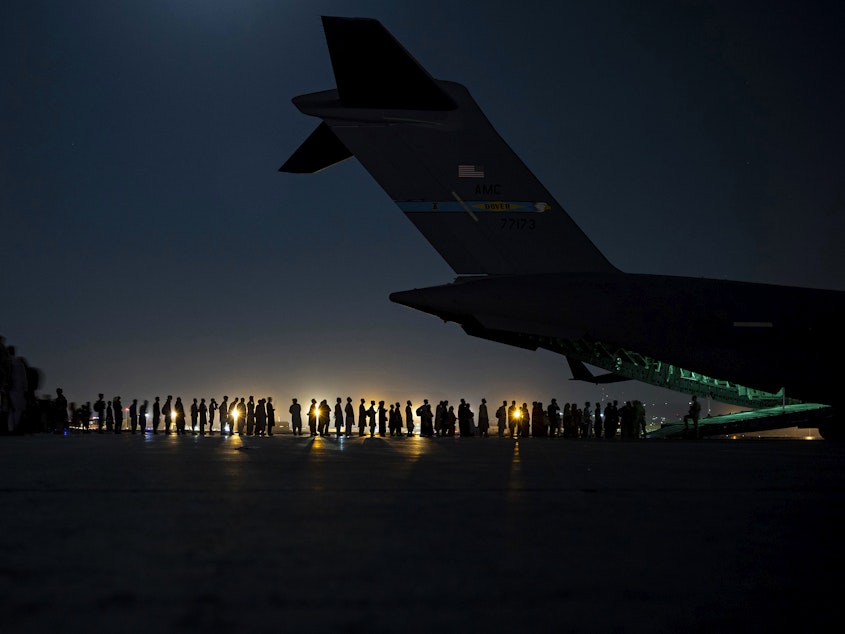caption: A U.S. Air Force air crew prepares to load evacuees aboard a C-17 aircraft at Hamid Karzai International Airport in Kabul, Afghanistan, on Aug. 31. Several public school students from Sacramento, Calif., remain in Afghanistan since the U.S. evacuation ended.
