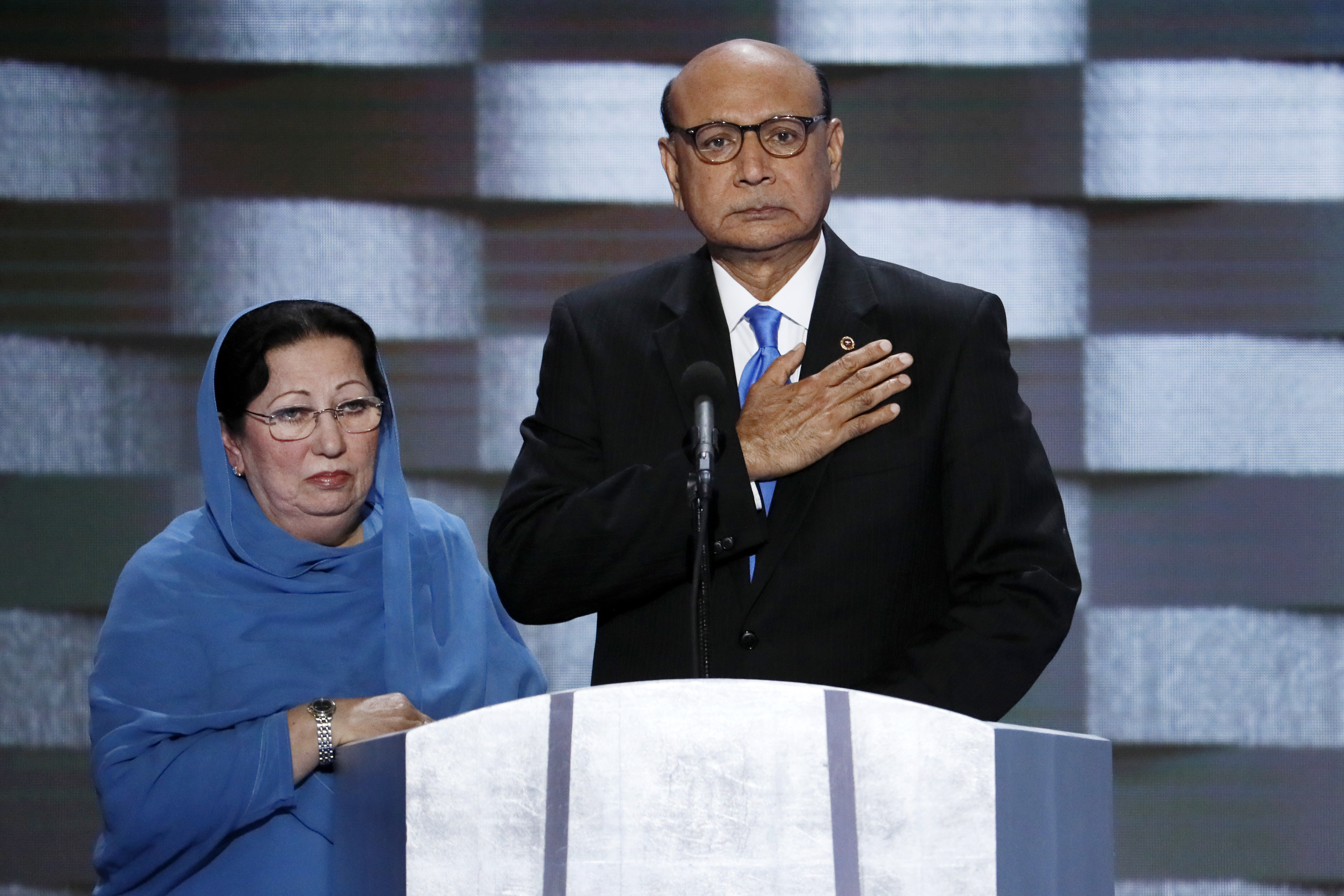 caption: FILE - In this July 28, 2016, file photo, Khizr Khan, father of fallen Army Capt. Humayun Khan and his wife Ghazala speak during the final day of the Democratic National Convention in Philadelphia. 
