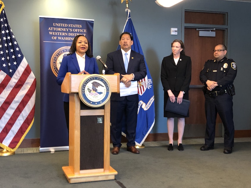 caption: The DOJ's Kristen Clarke announced a joint motion to end the  consent decree on March 28, 2023, accompanied by Seattle Mayor Bruce Harrell, City Attorney Ann Davison and SPD Chief Adrian Diaz. 