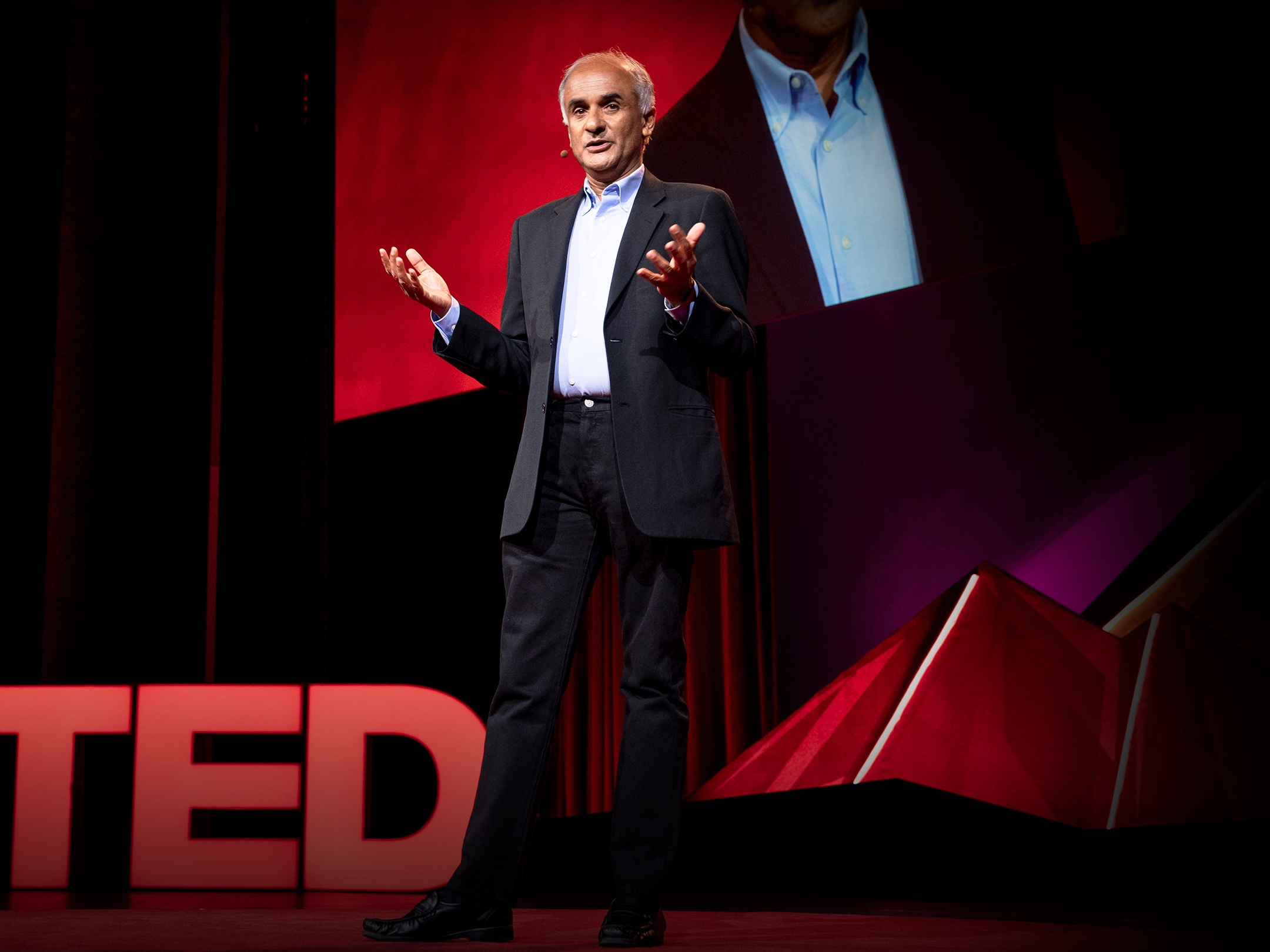 caption: Pico Iyer speaks at TEDSummit in 2019