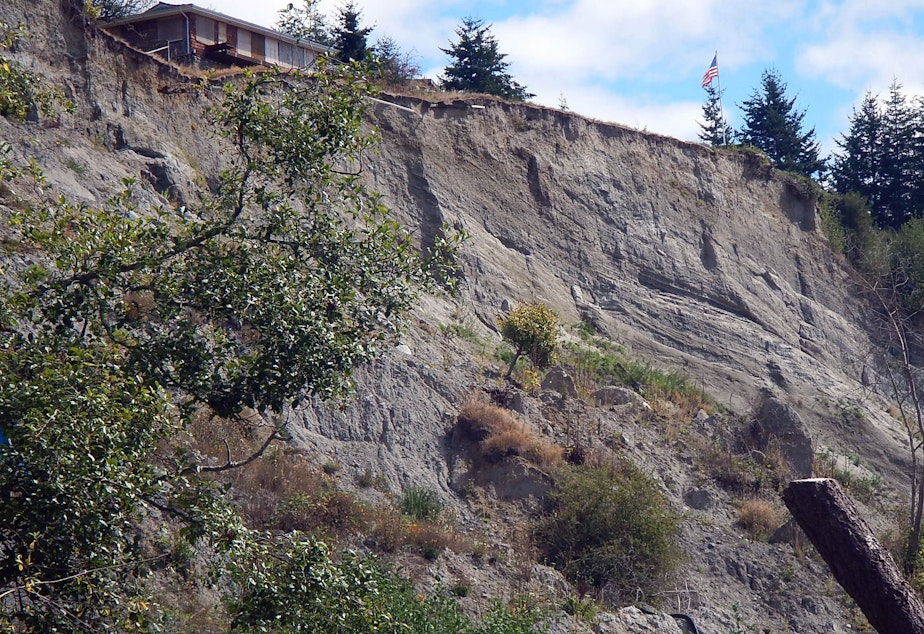 caption: A condemned house on the edge of the Ledgewood Beach landslide on Whidbey Island.