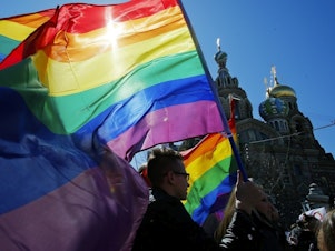 caption: Gay rights activists carry rainbow flags as they march during a May Day rally in 2013 in St. Petersburg, Russia. Russia's Supreme Court on Thursday effectively outlawed LGBTQ+ activism, in the most drastic step against advocates of gay, lesbian and transgender rights in the increasingly conservative country.