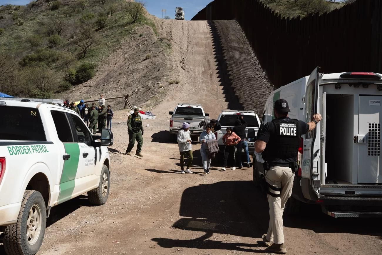 caption: Border Patrol picks up a group of asylum seekers from an aid camp at the US-Mexico border near Sasabe, Arizona, US, on Wednesday, March 13, 2024. The Tucson sector in Arizona, recorded the most unauthorized crossings of any region patrolled by the agency, according to federal government statistics.
