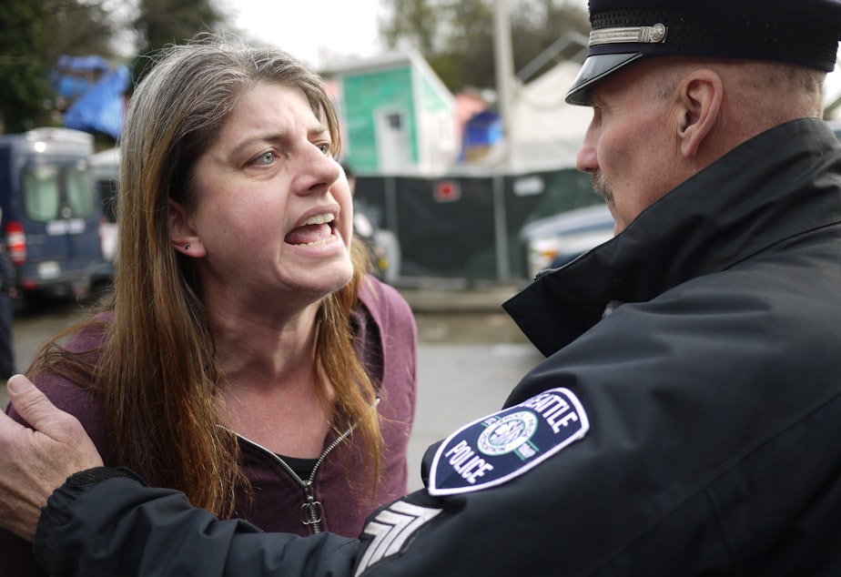caption: Resident Cecilia Carey objected to the clearing of the former Nickelsville homeless encampent on South Dearborn Street by police and city officials on the morning of Friday, March 11.