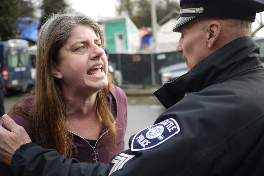 caption: Resident Cecilia Carey objected to the clearing of the former Nickelsville homeless encampent on South Dearborn Street by police and city officials on the morning of Friday, March 11.