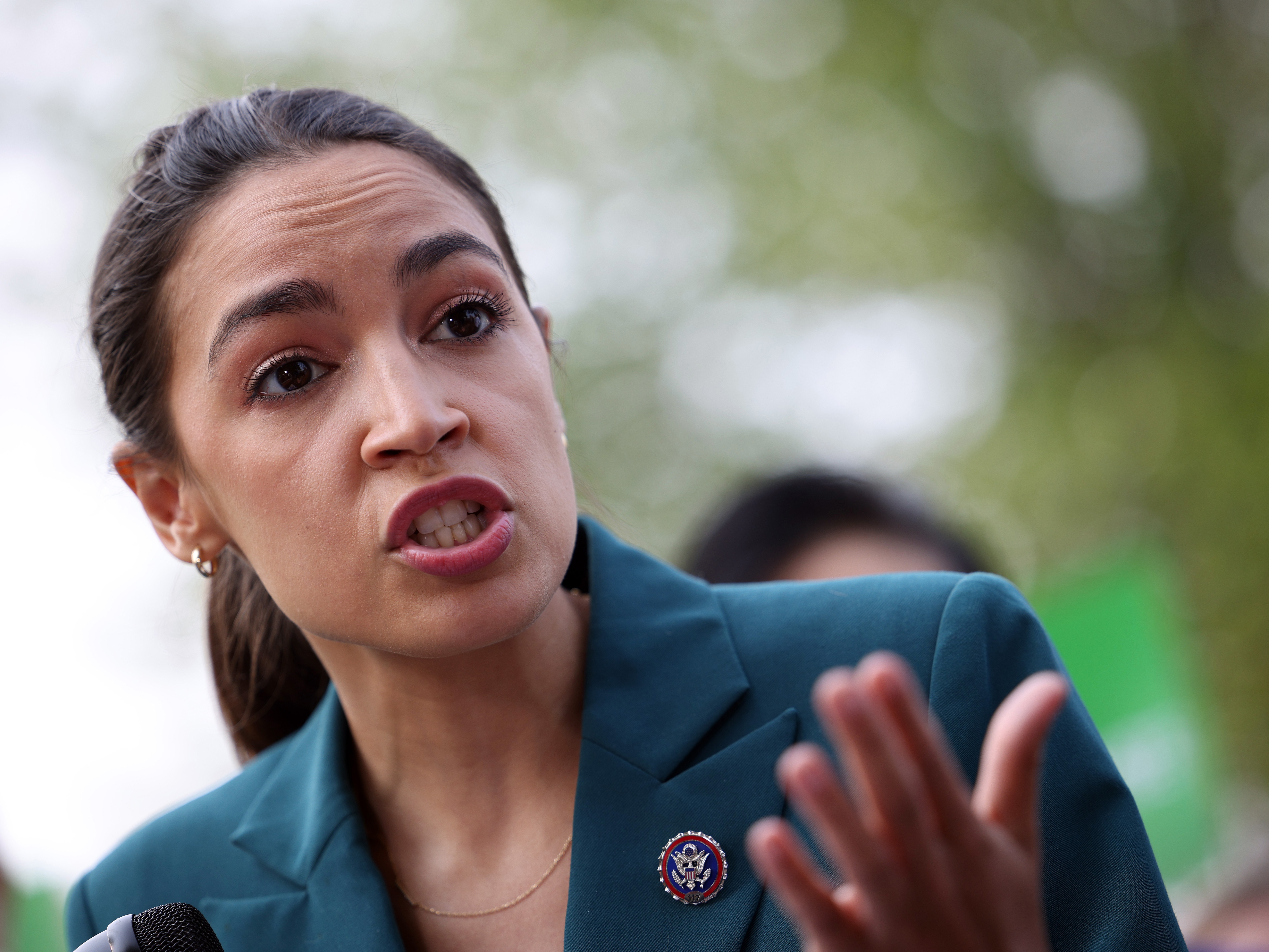 caption: Rep. Alexandria Ocasio-Cortez (D-NY) speaks at a press conference outside of the U.S. Capitol on July 20, 2021 in Washington, DC. 