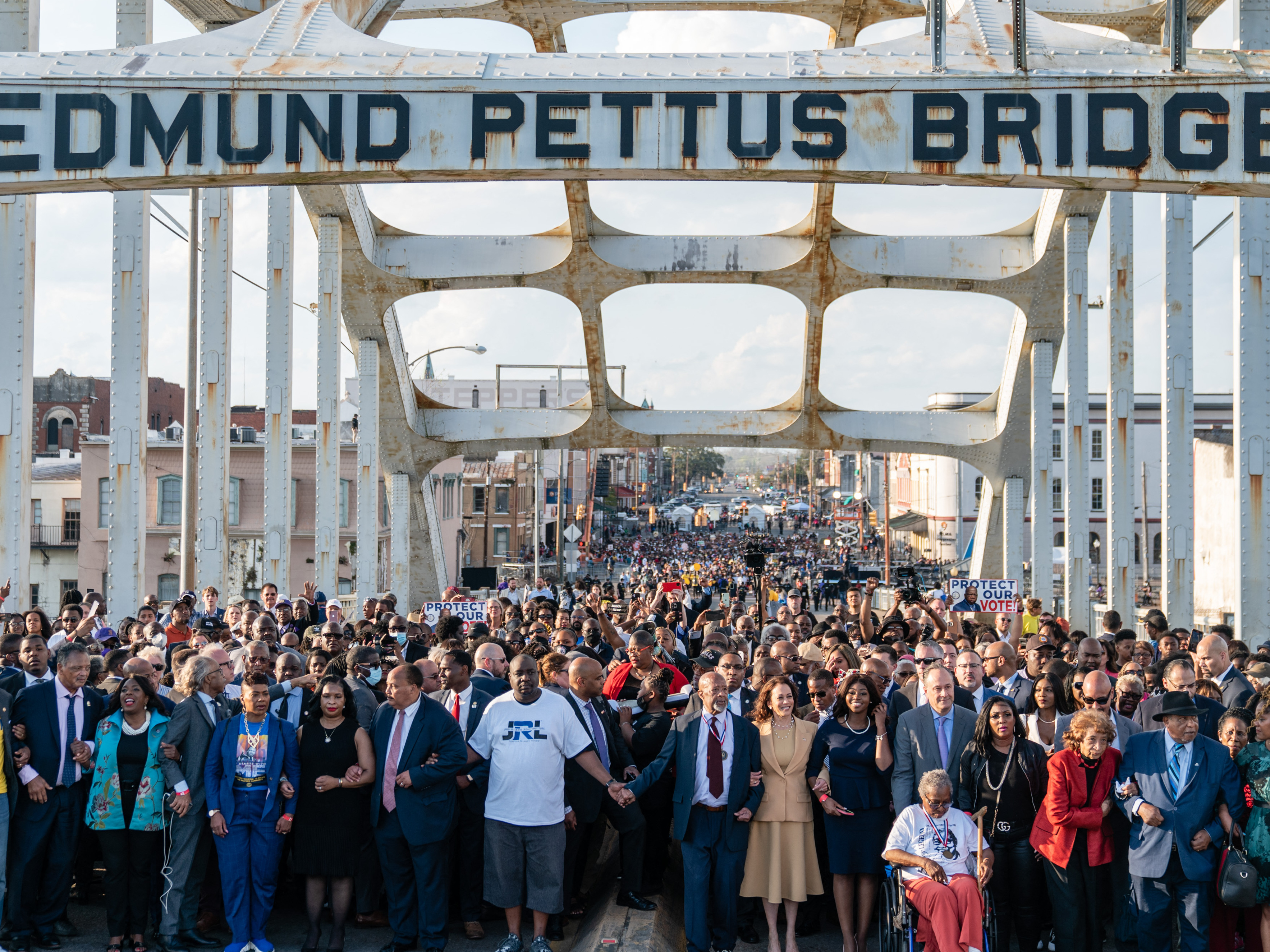 caption: Vice President Harris (center) marches across the Edmund Pettus Bridge on March 6, 2022,  in Selma, Ala., to commemorate the 57th anniversary of Bloody Sunday.