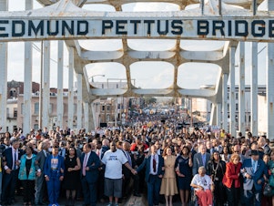 caption: Vice President Harris (center) marches across the Edmund Pettus Bridge on March 6, 2022,  in Selma, Ala., to commemorate the 57th anniversary of Bloody Sunday.