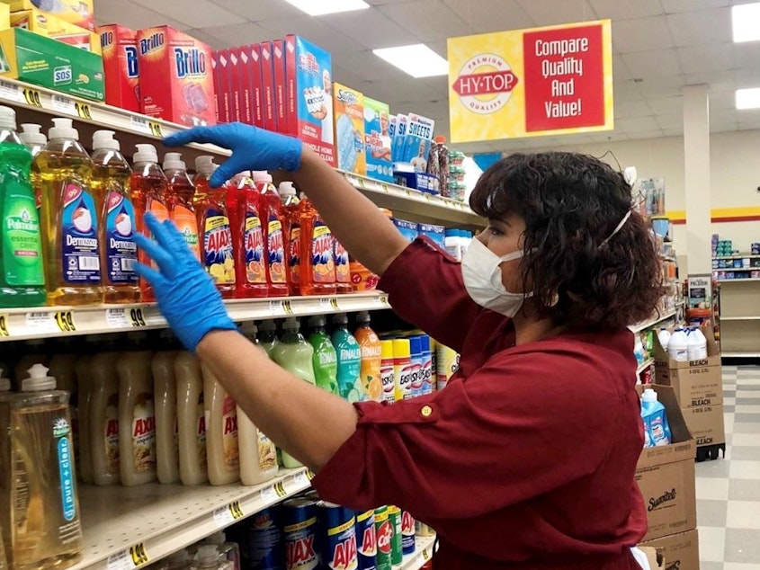 caption: Yesenia Ortiz works at a grocery store in Greensboro, N.C. She says she wishes she would get paid more during the pandemic because of the extra level of risk to which she is exposed.