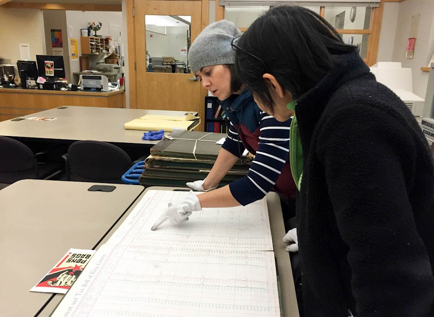 caption: Online editor Isolde Raftery reads an old residential ledger at the Puget Sound Regional Branch of the Washington State Archives in Bellevue.