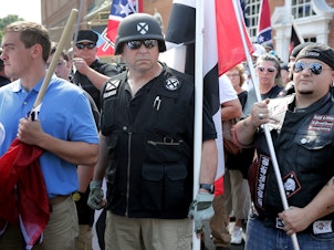 caption: Hundreds of white nationalists, neo-Nazis and members of the "alt-right" march down East Market Street toward Emancipation Park during the "Unite the Right" rally August 12, 2017 in Charlottesville, Virginia.