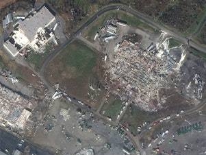 caption: <strong>BEFORE</strong> (left): Overview of Mayfield Consumer Products Candle Factory and nearby buildings before the tornado on Jan. 28, 2017. <strong>AFTER</strong> (right) Overview of the damage to the Mayfield Consumer Products Candle Factory and nearby buildings after the tornado on Dec. 11, 2021.