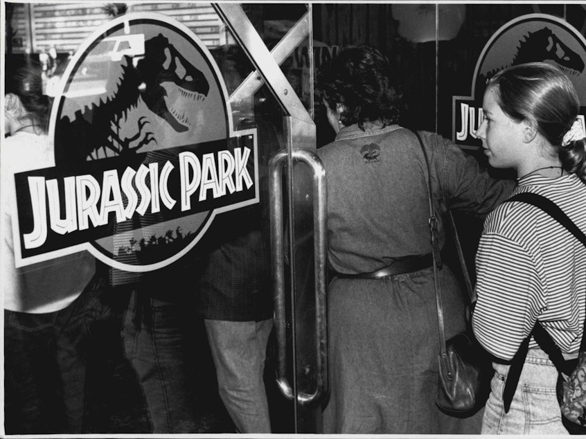 caption: A crowd entering the theater to see <em>Jurassic Park</em>, photographed on October 5, 1993.