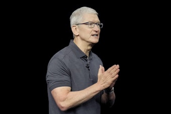 caption: Apple CEO Tim Cook speaks during an announcement of new products on the Apple campus in September 2023.