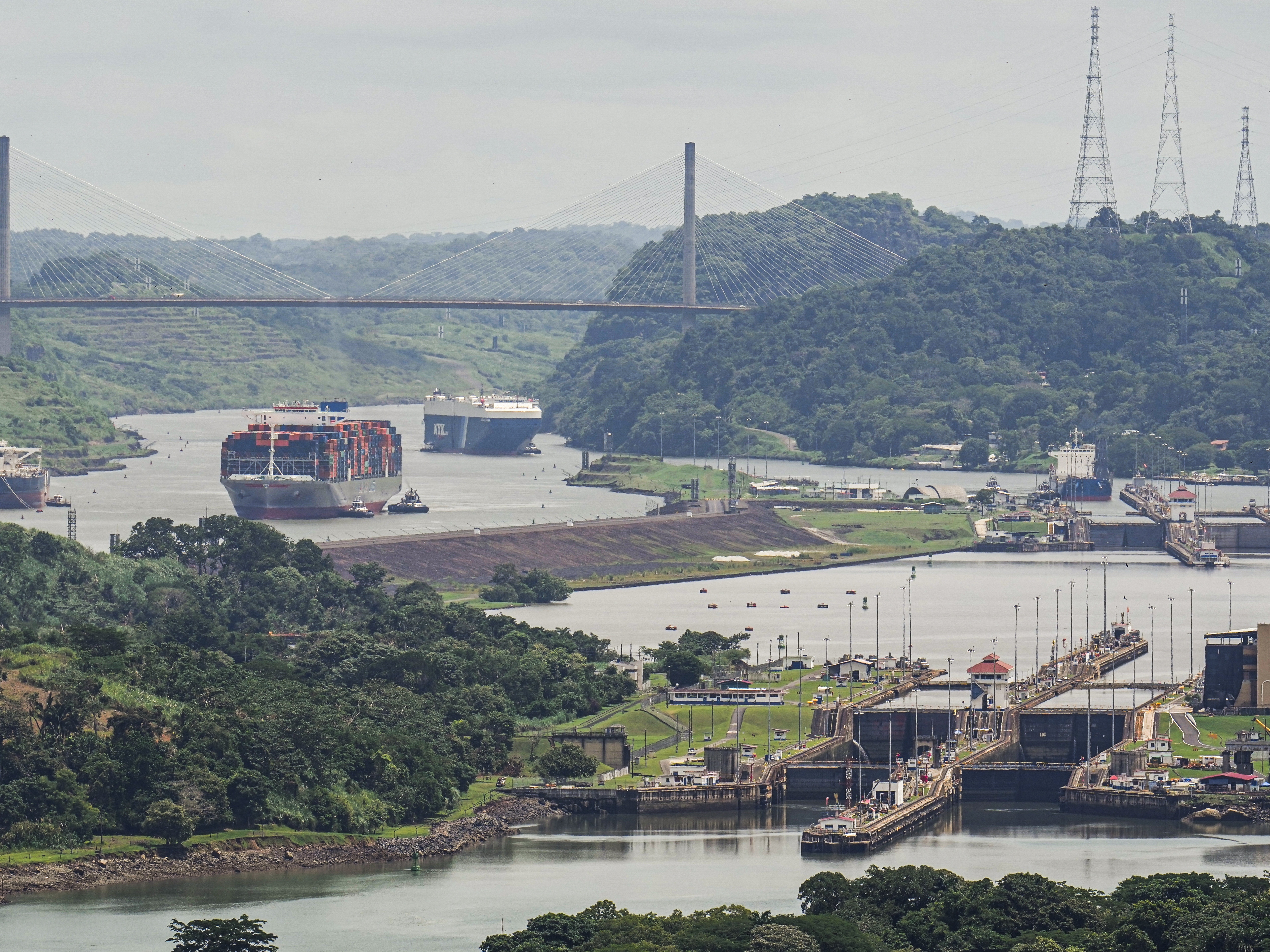 caption: A cargo ship navigates through the Panama Canal, seen from the Cerro Ancon in Panama City.
