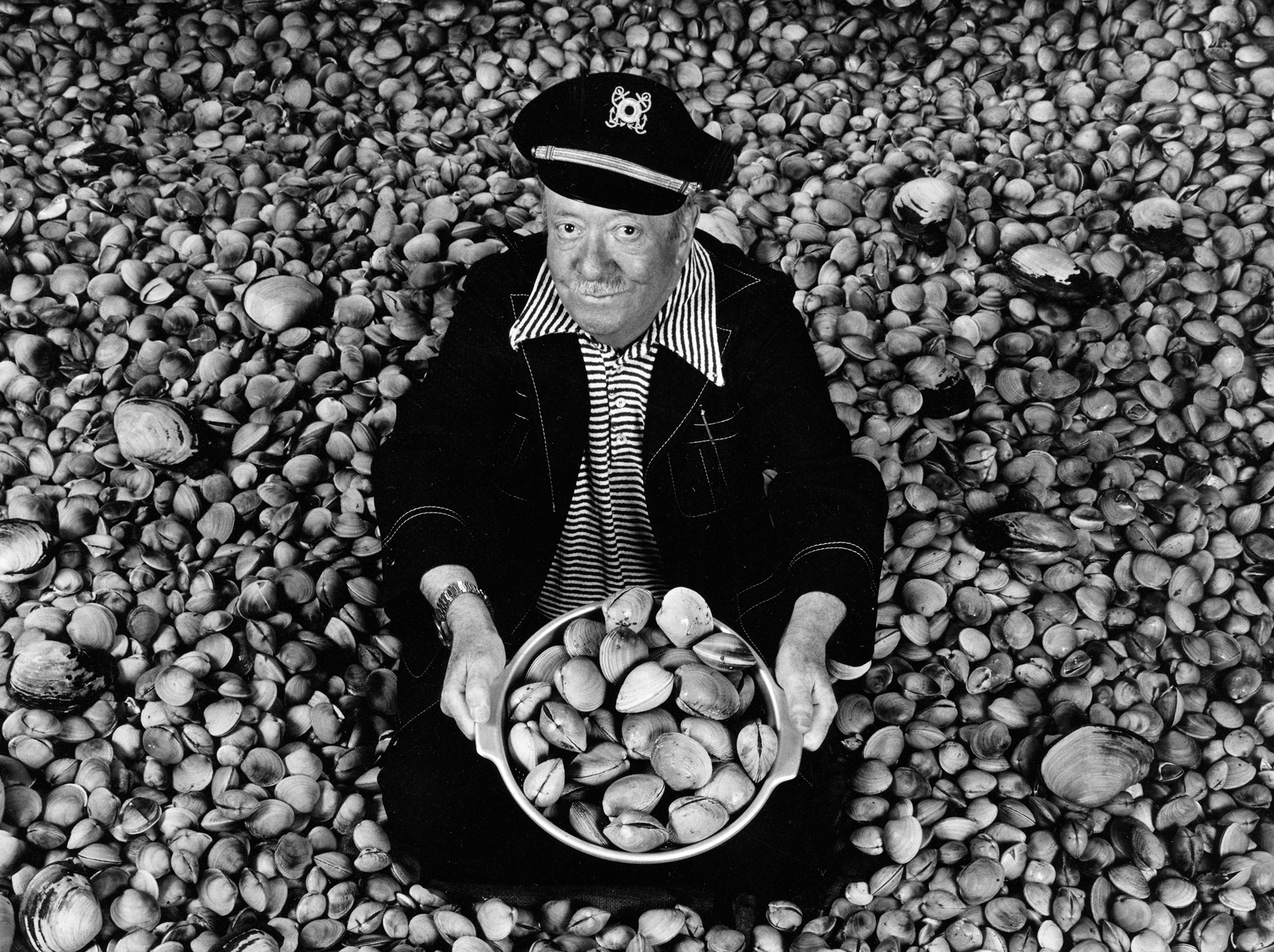 caption: This photo at the Nordic Heritage Museum exhibit shows Ivar Haglund 'surrounded by acres of clams,' a reference to his resaturant theme song.