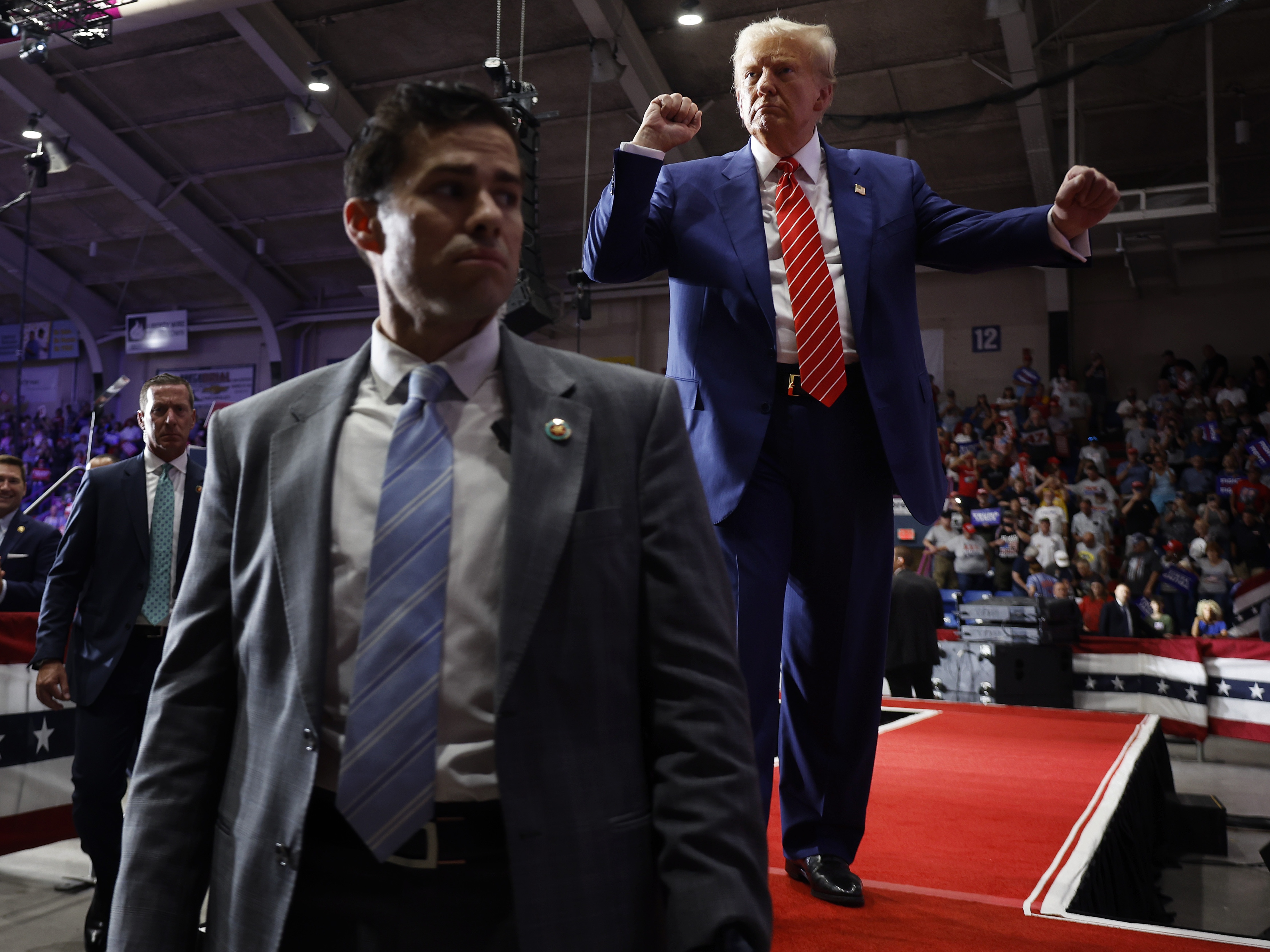 caption: Surrounded by U.S. Secret Service agents, the Republican presidential nominee, former President Donald Trump, dances his way offstage.