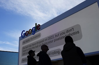 caption: Workers help set up the Google booth at the Las Vegas Convention Center before the start of the CES tech show, Monday, Jan. 2, 2023, in Las Vegas.