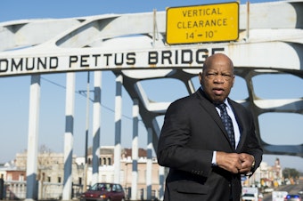 caption: The late Rep. John Lewis stands on the Edmund Pettus Bridge in Selma, Ala., in 2015, where he was beaten by police on "Bloody Sunday."