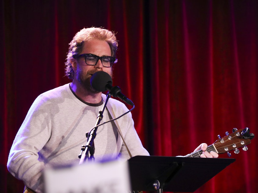 caption: House musician Jonathan Coulton leads a parody game on Ask Me Another at the Bell House in Brooklyn, New York.