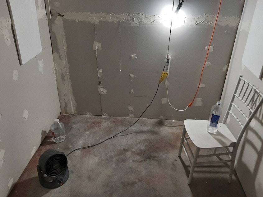 caption: This undated photo provided by the Federal Bureau of Investigation's Portland Field Office shows the interior of a makeshift cinderblock cell in Klamath Falls, Ore., allegedly used as a prison cell from which a woman eventually escaped and found help.