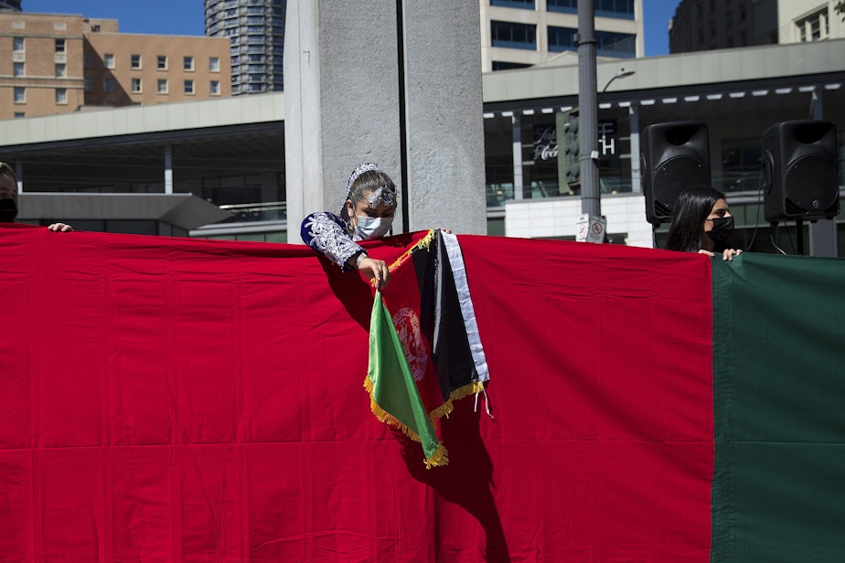 caption: About 100 people attended a rally and march organized by Afghans of Seattle, a new organization composed of young Afghan-Americans in the greater Seattle area, to stand in solidarity with Afghans on Saturday, August 28, 2021, at Westlake Park in Seattle.