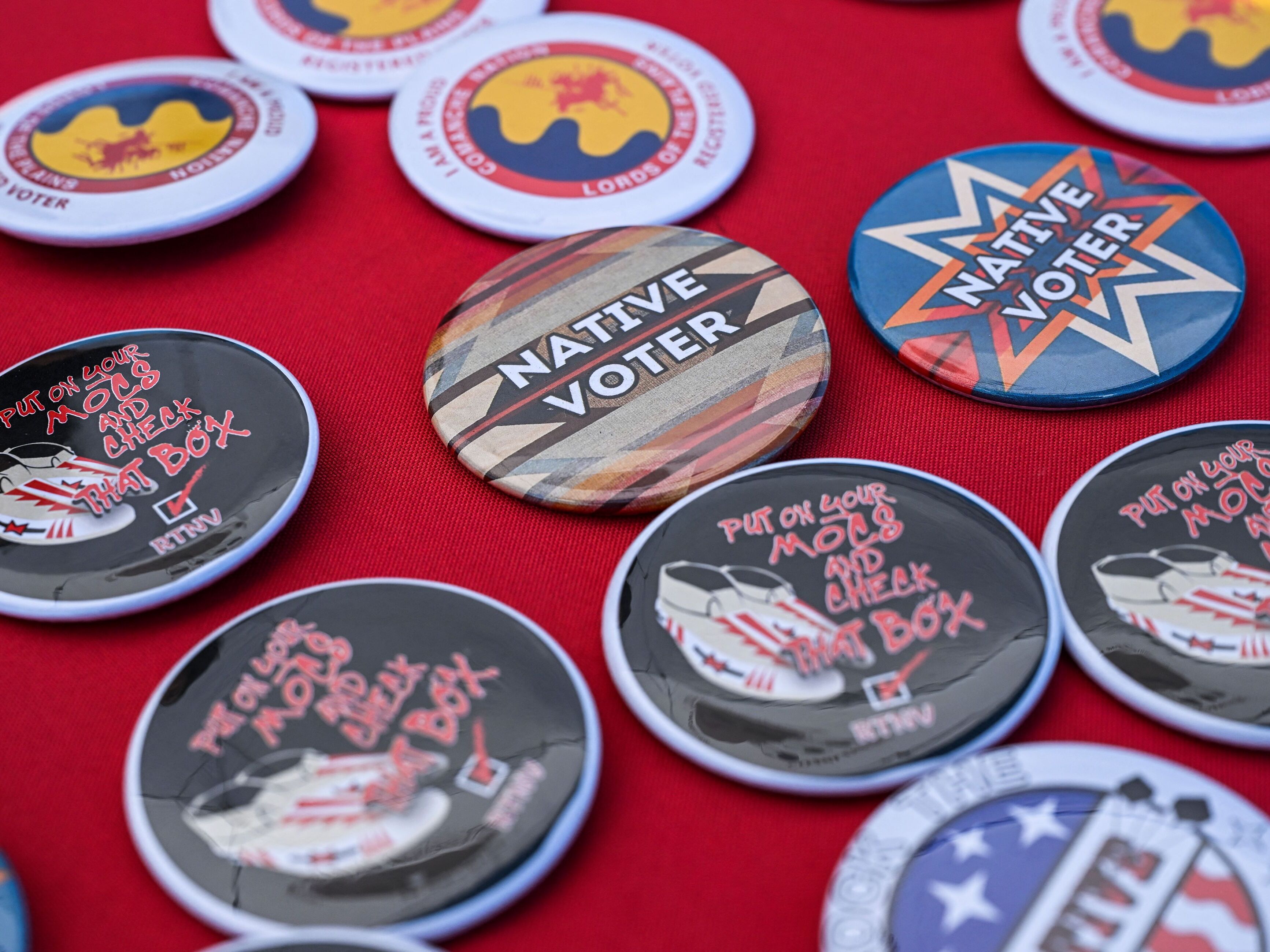 caption: Pins are pictured at a counter during a cultural meeting at the Comanche Nation fairgrounds in Lawton, Okla., in September 2023.