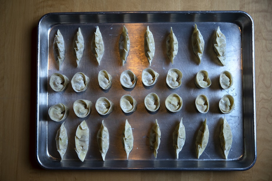 caption: A tray of dumplings made by Sara Upshaw, owner of OHSUN Banchan Deli & Cafe, is shown on Tuesday, February 6, 2024, at the restaurant in Seattle’s Pioneer Square neighborhood. 