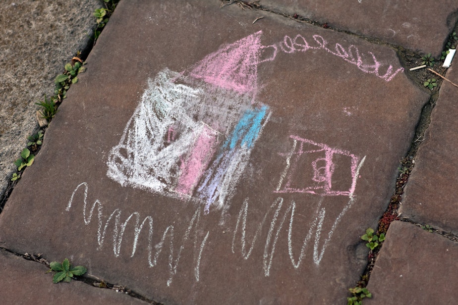 caption: A child's sidewalk chalk drawing.