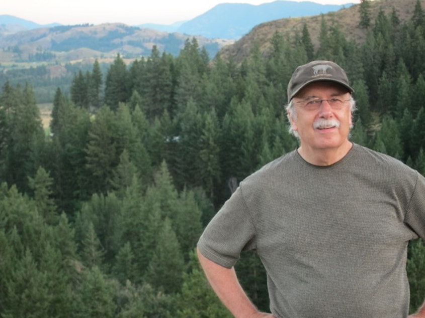 caption: Don Nelson, the editor-owner of the Methow Valley News, with the Methow Valley in the background. The fires this season are the biggest on record in Washington state.