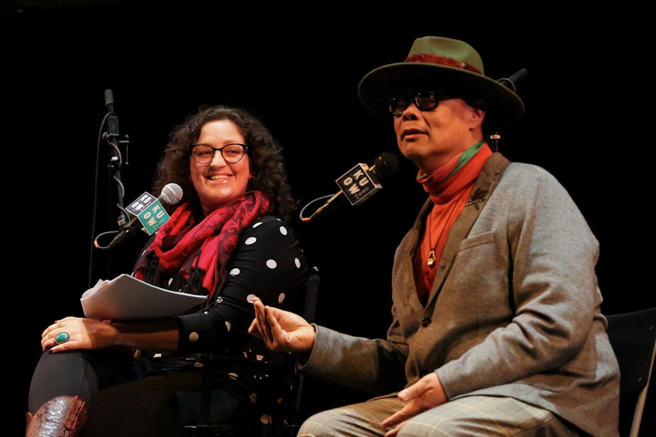 caption: KUOW Cat Smith, and Wing Luke Museum Executive Director Joël Barraquiel chatted with the panel at the Cornish Playhouse in Seattle on Thursday, December 14 during the Year In Review event.