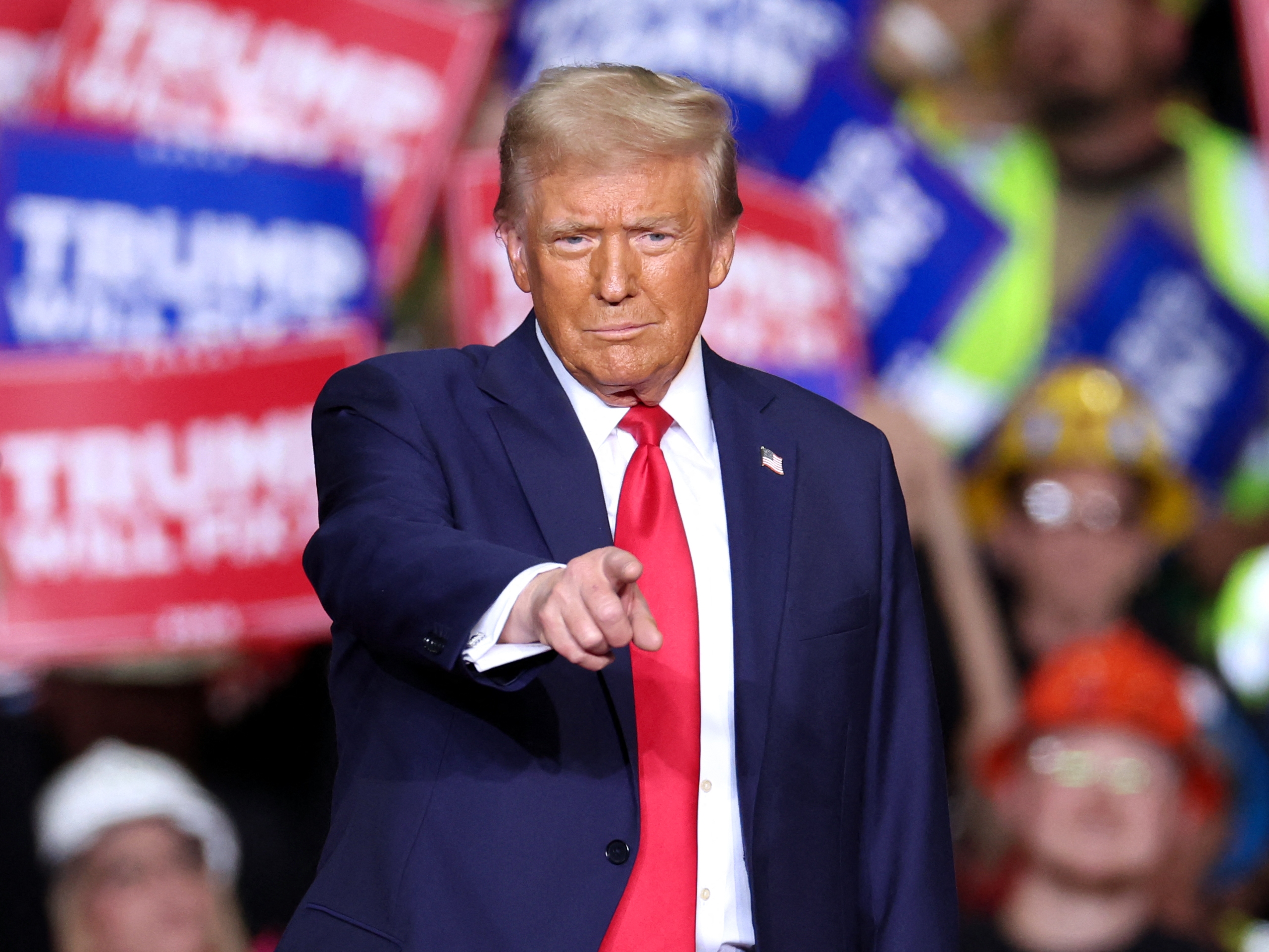 caption: Former President and Republican presidential candidate Donald Trump gestures during a campaign rally in Pittsburgh, Pa., on Monday, the night before Election Day.