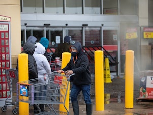caption: People wait in long lines at an H-E-B grocery store in Austin, Texas, on Wednesday. The large supermarket chain said the "unprecedented weather event in Texas has caused a severe disruption in the food supply chain."