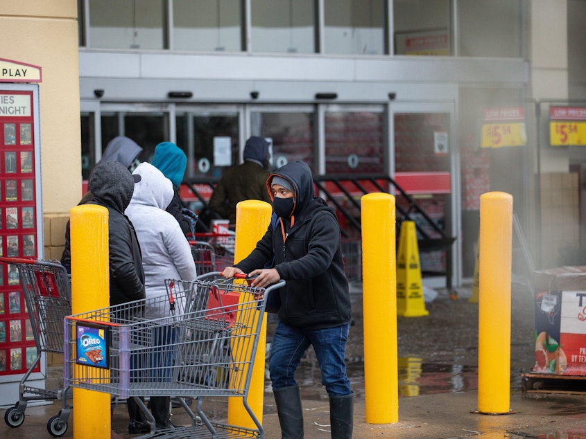 caption: People wait in long lines at an H-E-B grocery store in Austin, Texas, on Wednesday. The large supermarket chain said the "unprecedented weather event in Texas has caused a severe disruption in the food supply chain."