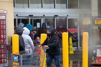 caption: People wait in long lines at an H-E-B grocery store in Austin, Texas, on Wednesday. The large supermarket chain said the "unprecedented weather event in Texas has caused a severe disruption in the food supply chain."