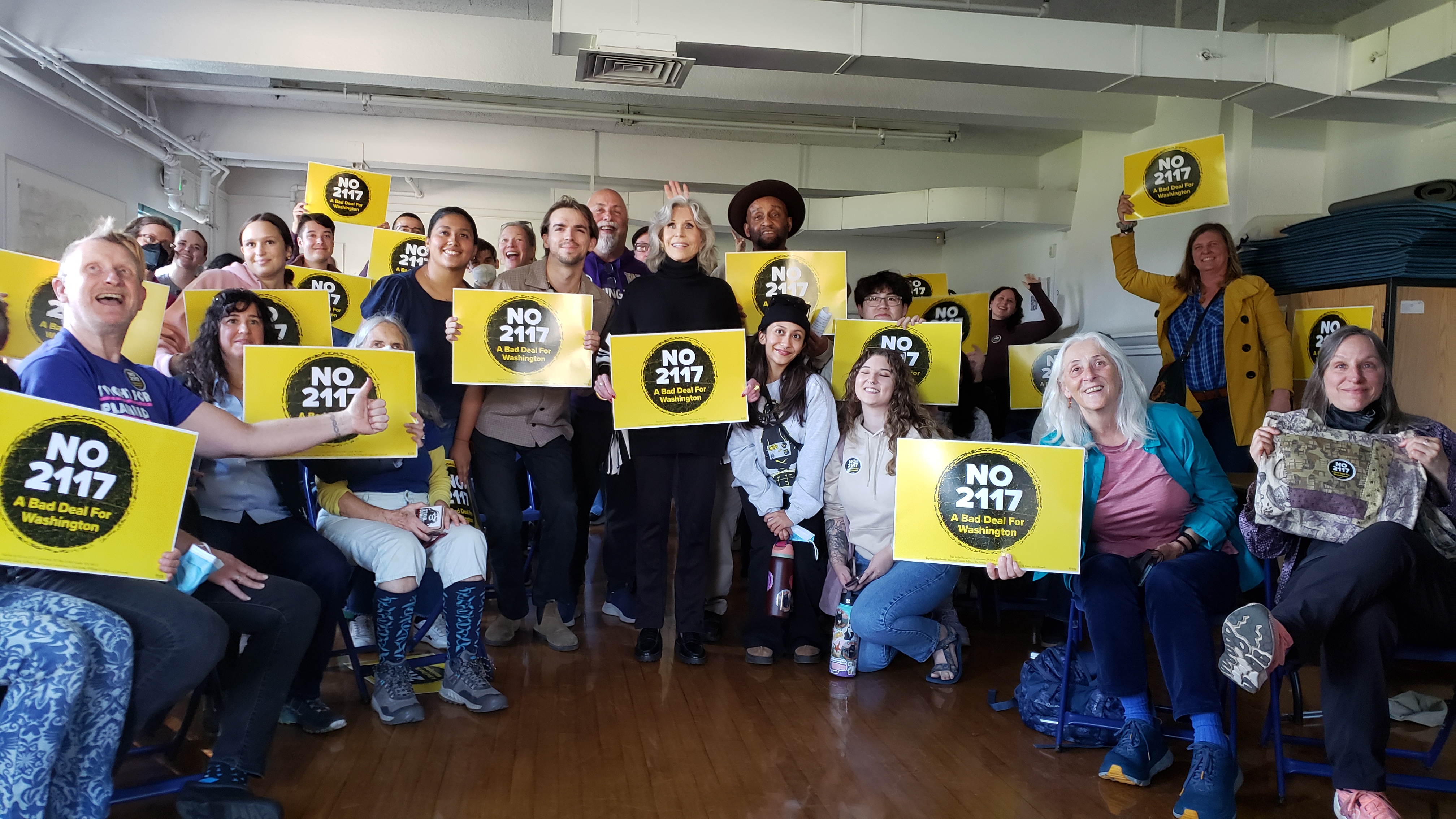 caption: Jane Fonda stands with opponents of I-2117 at the Green Lake Community Center on Wednesday, October 9, 2024.