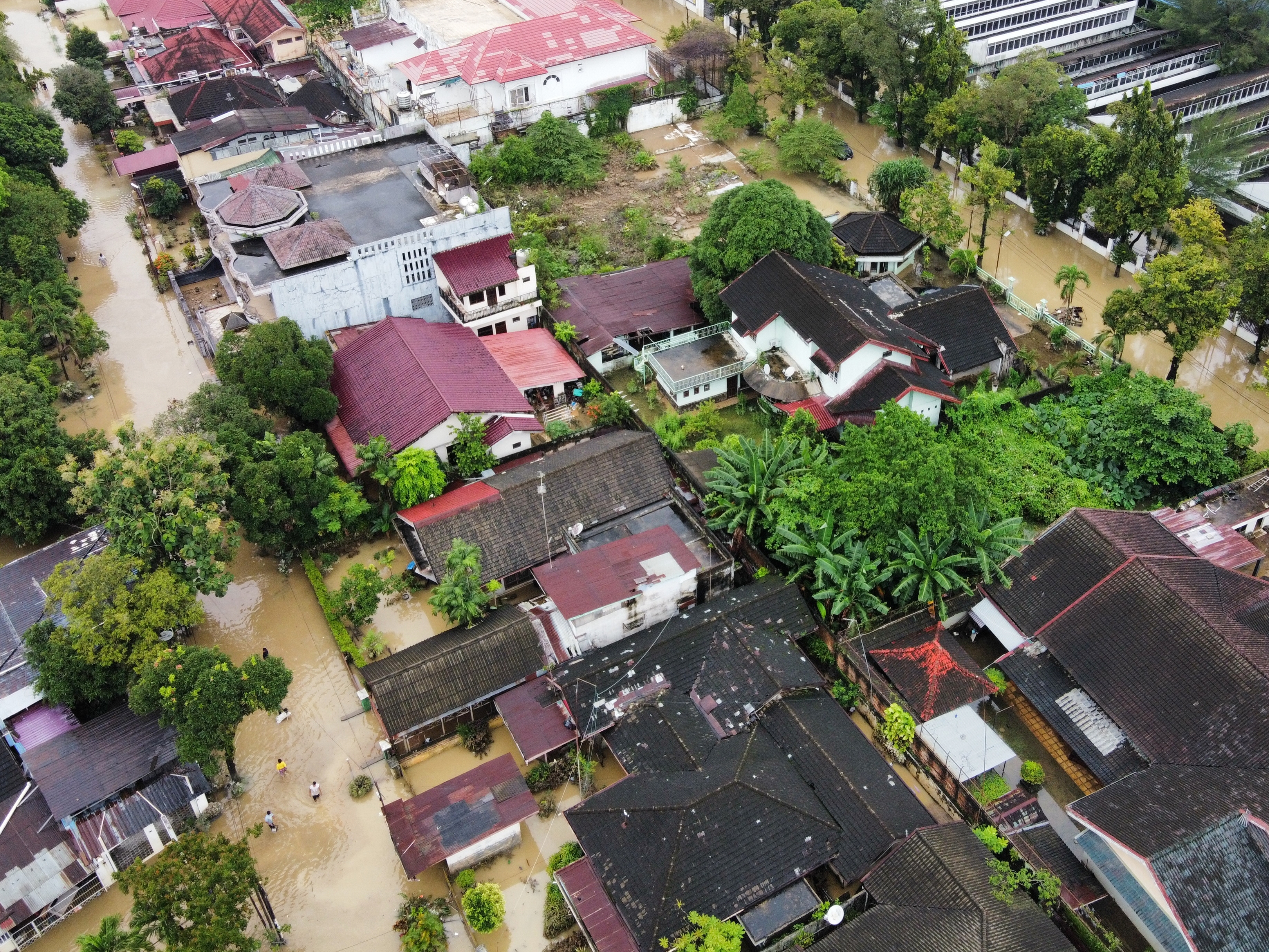 caption: This aerial shot taken using a drone shows a flooded neighborhood in Medan, North Sumatra, Indonesia, Friday, Nov. 28, 2025.