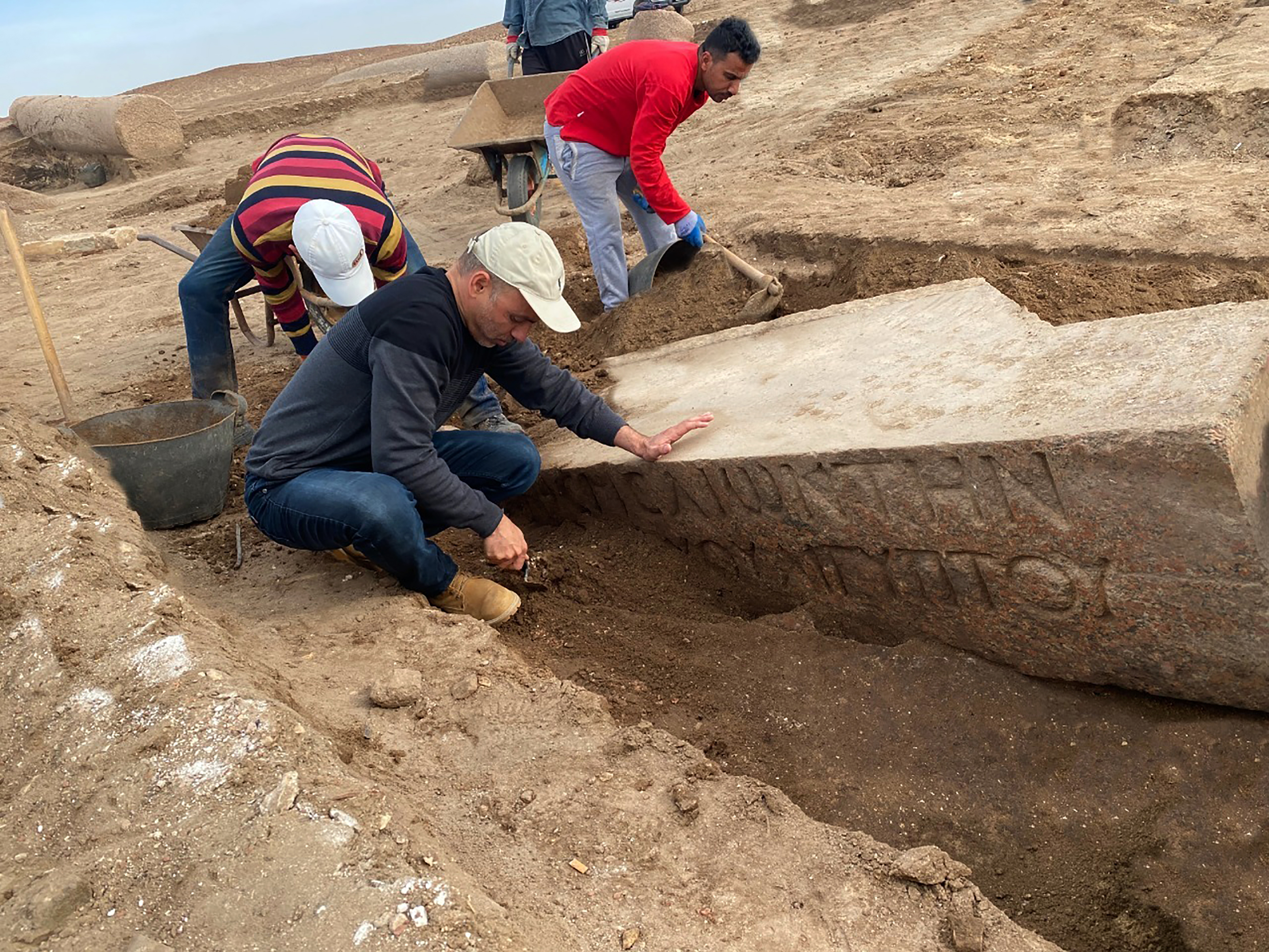 caption: Archeologists work in the ruins of a temple for Zeus-Kasios, the ancient Greek god, at the Tell el-Farma archaeological site in the northwestern corner of the Sinai Peninsula. Tell el-Farma, also known by its ancient name Pelusium, dates back to the late Pharaonic period and was also used during Greco-Roman and Byzantine times.