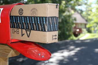 caption: A box containing an order from Amazon.com is shown after it was delivered to a house in Etters, Pa, Wednesday, Sept 16, 2005.